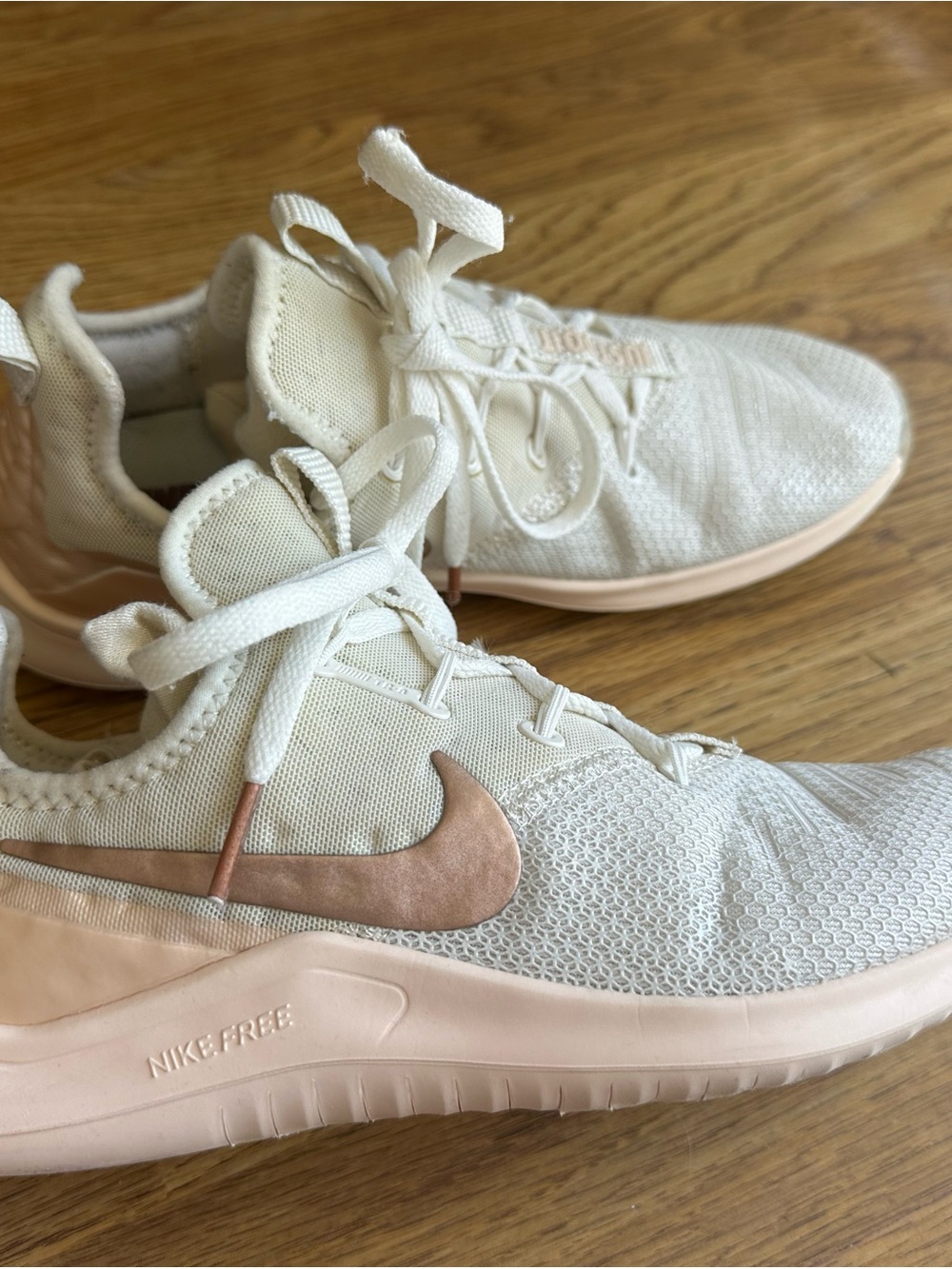 Nike Women's Sneakers in Cream with Blush Swoosh